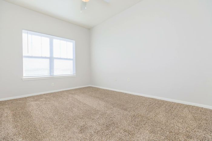 Cozy and spacious bedroom featuring modern decor at Southwest Pines, Tyler, TX