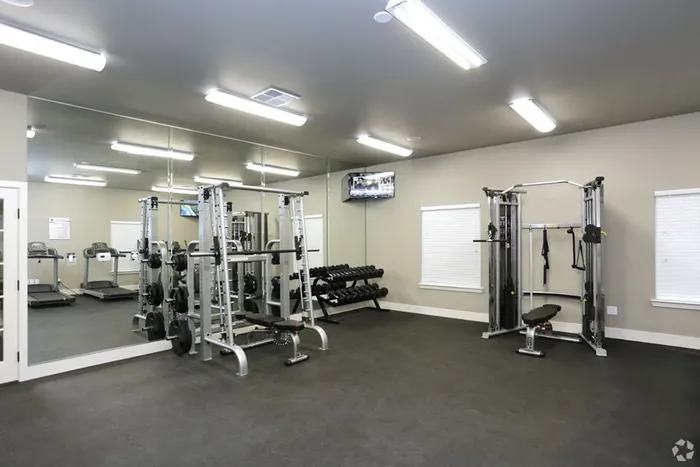 State-of-the-art fitness center with strength training equipment at Arroyo Seco Villas in San Antonio, TX.