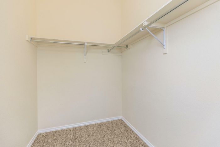 A well-organized walk-in closet with ample shelving at Bella Vista Place, El Paso, TX