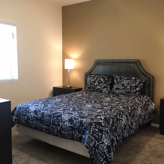 A spacious bedroom with natural light and modern decor at Bella Vista Place, El Paso, TX