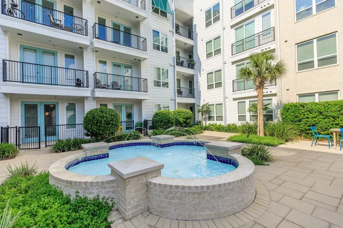 small fountain in a courtyard surrounded by apartment buildings