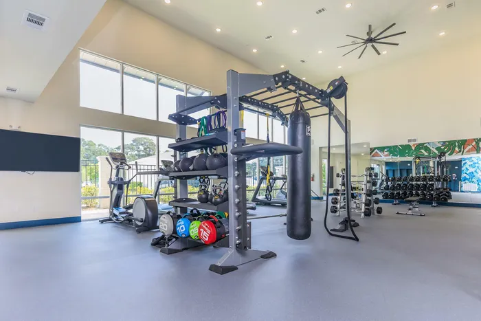 spacious fitness center with exercise equipment and weights