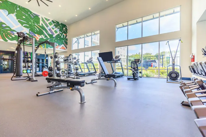 spacious fitness center with exercise equipment and weights