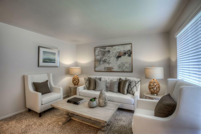 A cozy dining room with a wooden table, elegant chairs, and decorative accents at Viewcrest Village in Bremerton, WA.