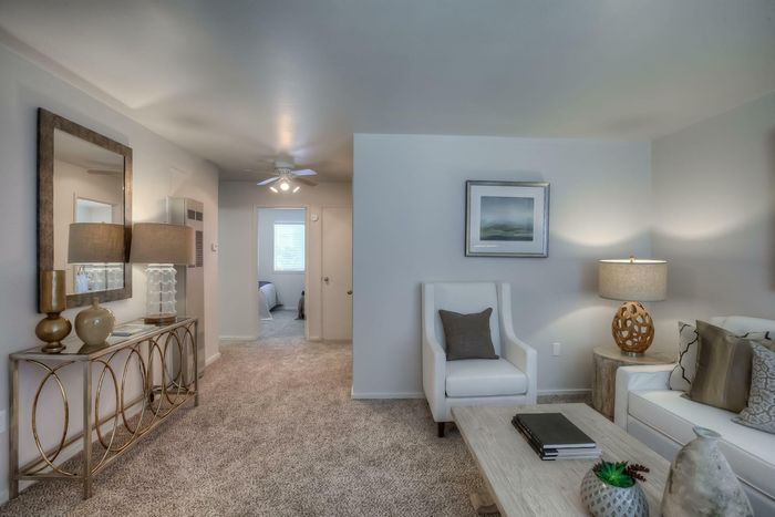 An elegant living room with modern decor and a hallway view that enhances the open layout at Viewcrest Village in Bremerton, WA.