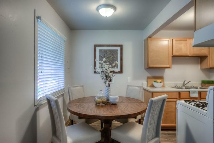 A cozy dining room with a wooden table, elegant chairs, and decorative accents at Viewcrest Village in Bremerton, WA.