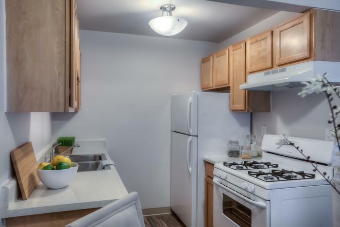 A modern kitchen with stainless steel appliances, white cabinetry, and stylish countertops at Viewcrest Village in Bremerton, WA