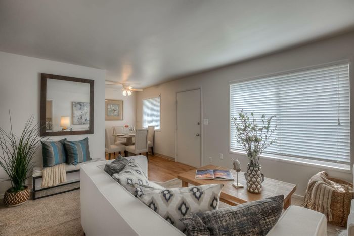 An elegant dining area with a polished wooden table, cushioned chairs, and decorative elements at Viewcrest Village in Bremerton, WA.