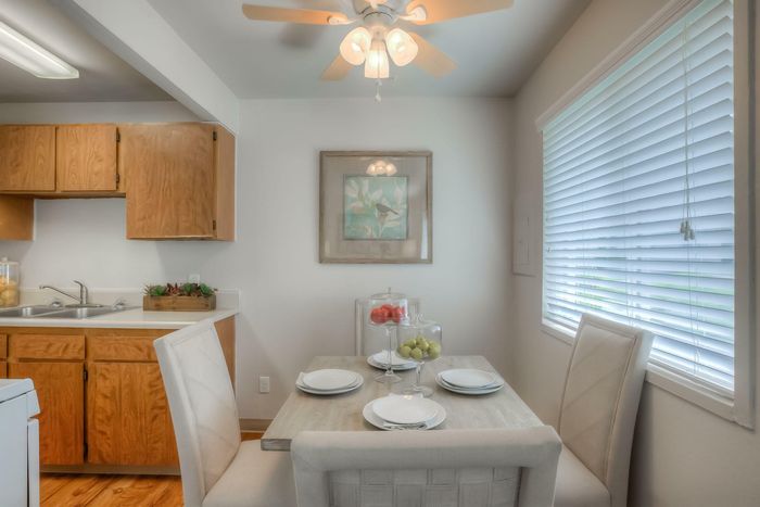 A bright dining room with natural light, comfortable seating, and a table set for meals at Viewcrest Village in Bremerton, WA.