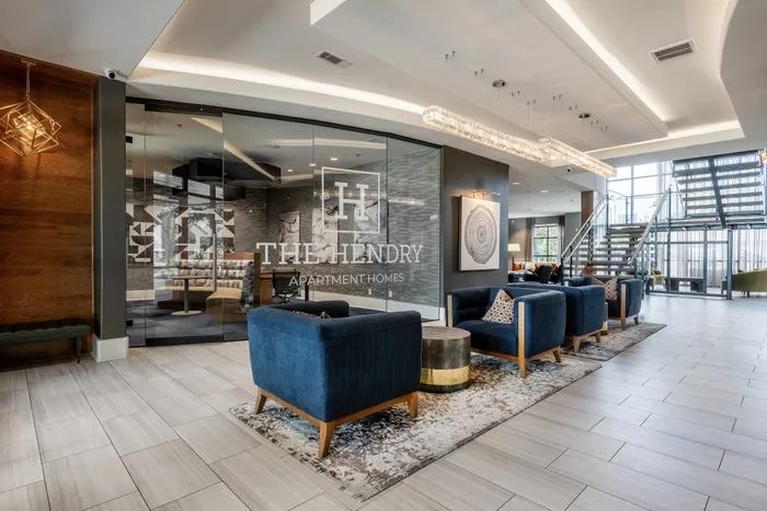 Stylish lobby with modern seating and glass accents at The Hendry Apartments in Garland, TX.