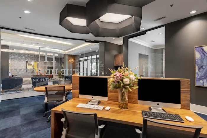 Modern business center with sleek workstations at The Hendry Apartments, Garland, TX.