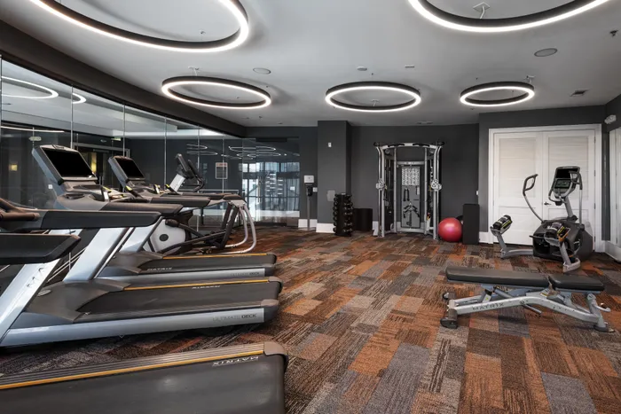 Fully equipped fitness center with modern cardio machines at The Hendry Apartments, Garland, TX.