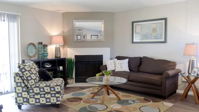 Cozy living room in Carrollton, TX apartment featuring a warm fireplace, modern decor, and natural light.