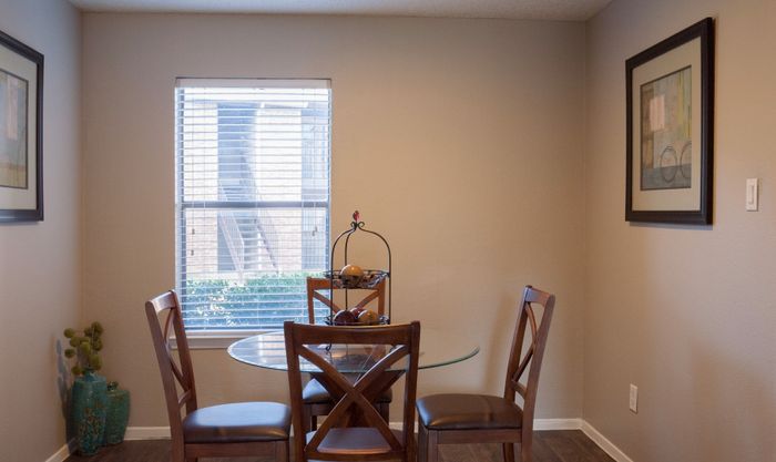 Bright dining room in a Carrollton, TX apartment with natural light and modern furnishings.
