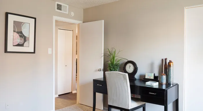 Stylish bedroom in Carrollton, TX apartment with elegant decor and modern lighting.