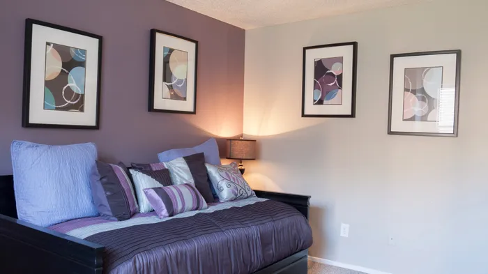 Stylish bedroom in Carrollton, TX apartment with elegant decor and modern lighting.