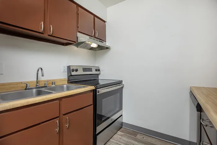 Modern kitchen with stainless steel appliances at Las Brisas Apartments in Albuquerque, NM.