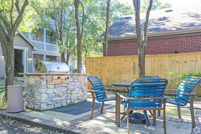outdoor patio with a large grill and table with chairs