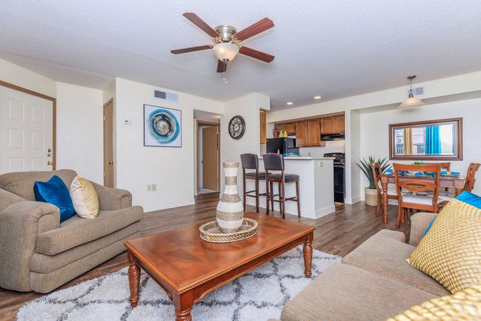 a spacious living room with a lot of natural light at Whispering Pines Apartments in El Paso, TX