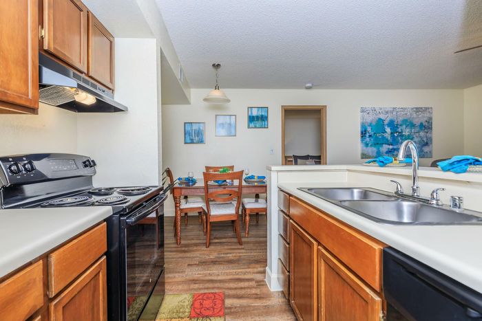 kitchen with modern appliances at Whispering Pines Apartments in El Paso, TX