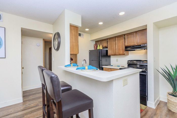 kitchen bar with seating at Whispering Pines Apartments in El Paso, TX