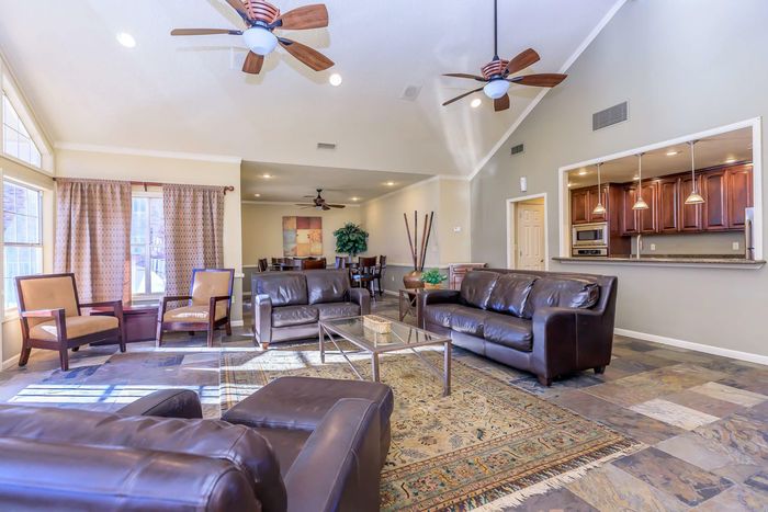 Spacious clubhouse interior with and ample natural lighting at Whispering Pines Apartments in El Paso, TX.