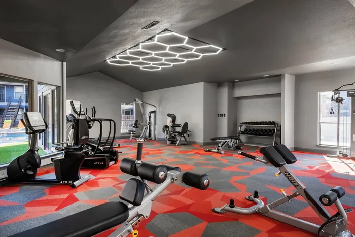 Fully equipped fitness room in a Carrollton, TX apartment complex with kettlebells and resistance bands.