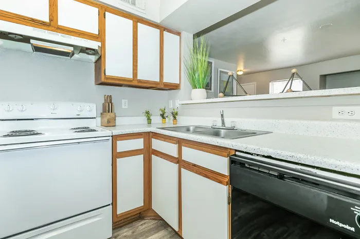 kitchen with white cabinets, a white oven, and a black dishwasher