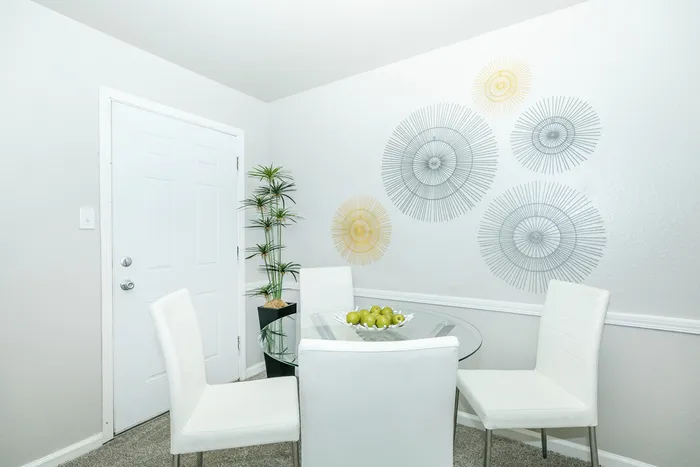 a table and chairs atop a carpeted floor