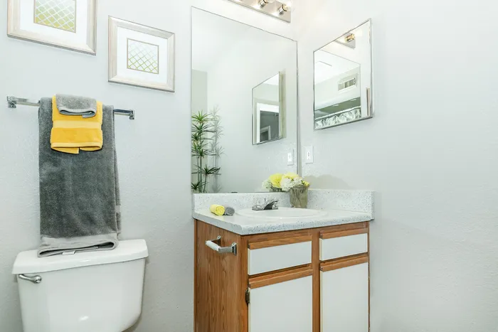 a bathroom an updated sink, clean fixtures, and a lot of light