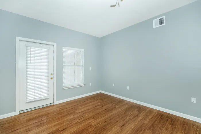 Modern living room with stylish furniture, large windows, and natural light at Portside Villas, Ingleside, TX.