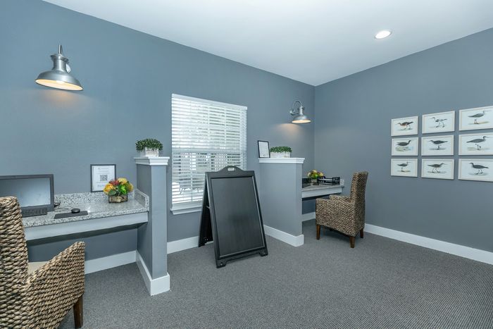 Business center with computers, desk space, and modern amenities at Portside Villas in Ingleside, TX