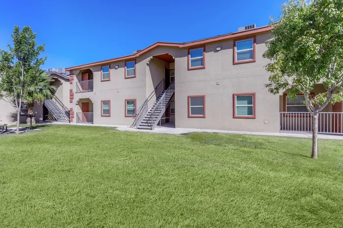 A scenic view of the apartment complex at Bella Vista Place, El Paso, TX, with lush green spaces