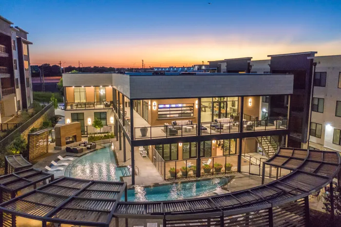 dusk lighting of the pool and surrounding seating area