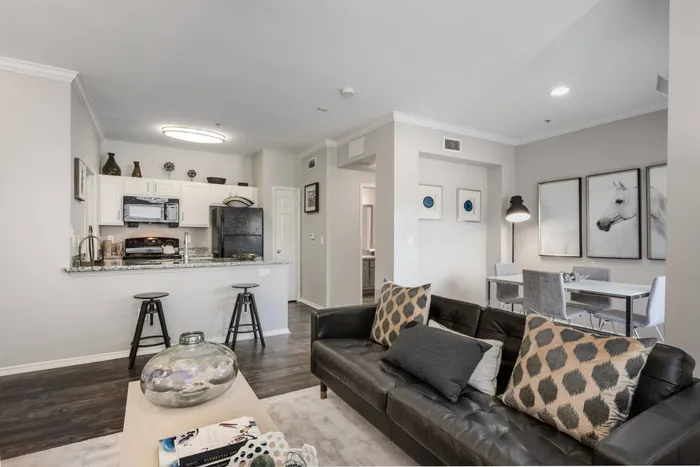 living area furnished with rugs, table, chairs, and plenty of decor