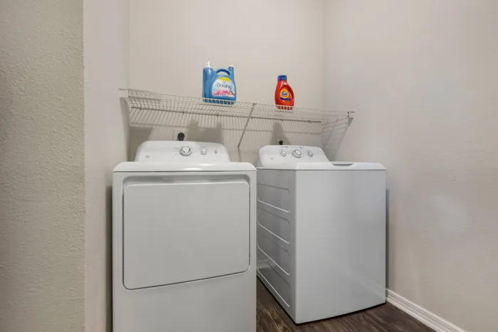 in-home washer and dryer with a shelf above both