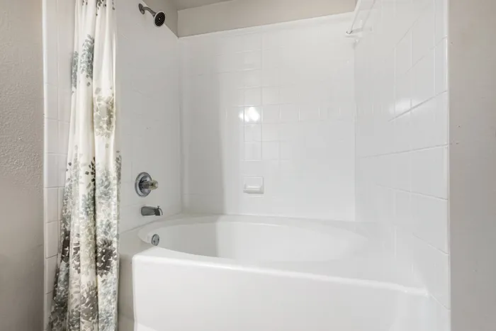 modern bathroom with a hardwood floor and a bathtub