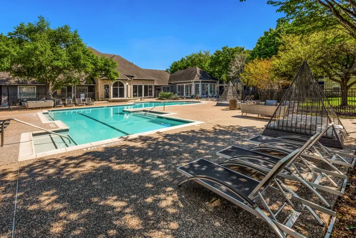 sparkling pool surrounded by large walkways and comfortable seating