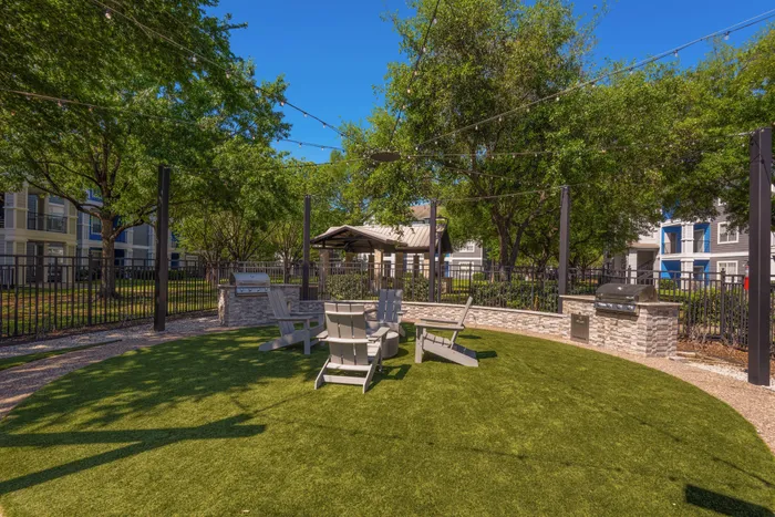 grassy area with grills and chairs