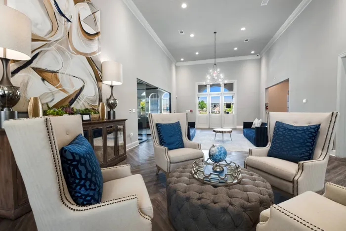 Spacious Community Club House with comfortable chairs and natural lighting from large windows