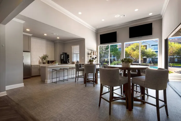 resident clubhouse with prep kitchen, a large bar, and lots of seating