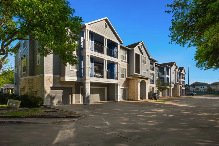 three-tiered apartment building with garages and balconies