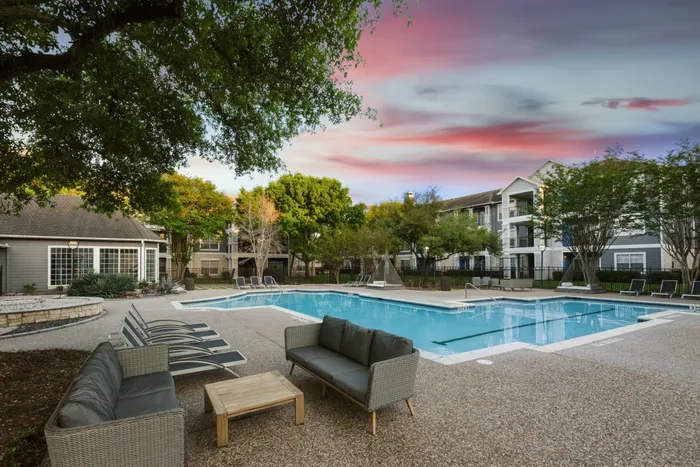 sparkiling pool with seating at sunset