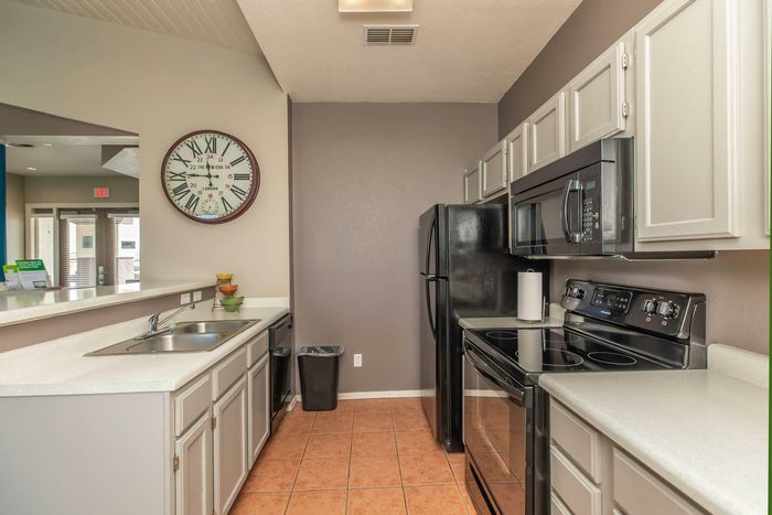 Fully-equipped kitchen in the clubhouse with modern appliances at Santa Teresa Terrace in Santa Teresa, NM.