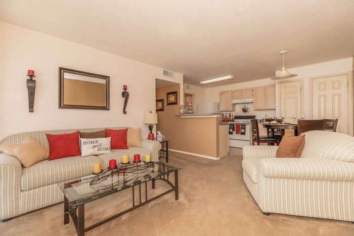 Living room with cozy seating, warm decor, and an open floor plan at Santa Teresa Terrace in Santa Teresa, NM.
