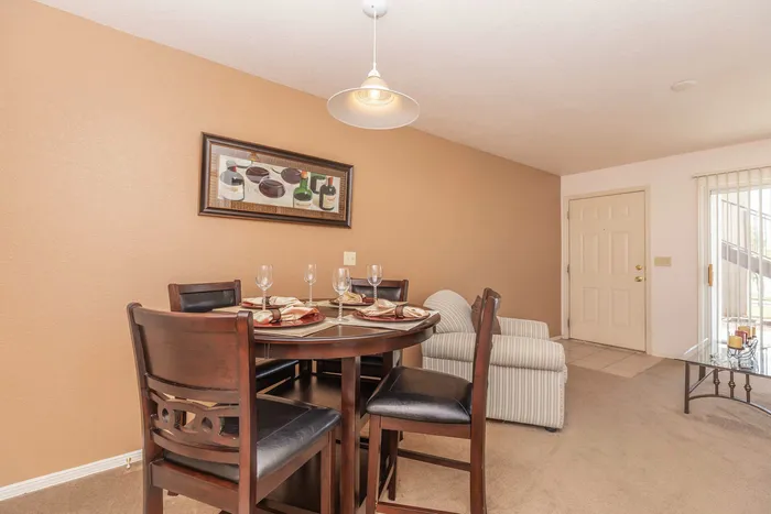 Open-concept dining area with modern appliances and wood cabinetry at Santa Teresa Terrace in Santa Teresa, NM.