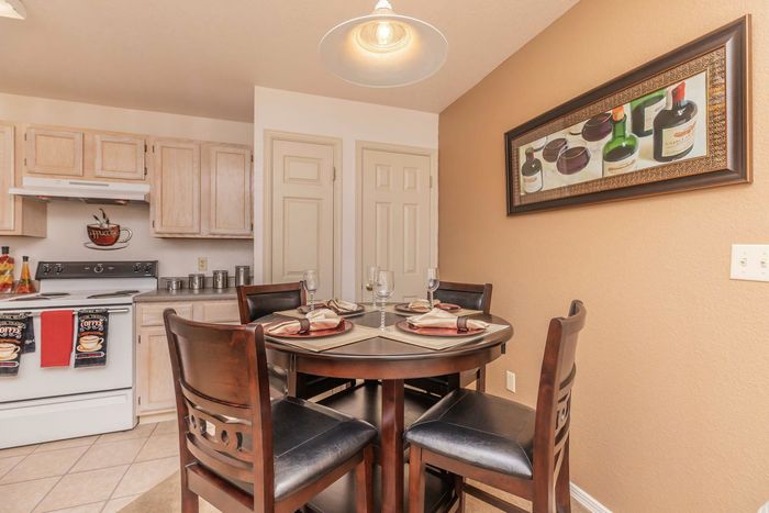 Dining area with a round table and chairs, set for a cozy meal, at Santa Teresa Terrace in Santa Teresa, NM.