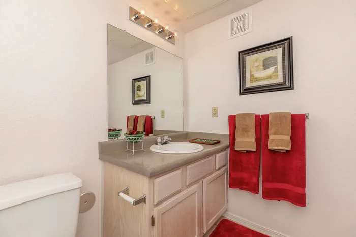 Bathroom with a bathtub, shower curtain, and vanity area at Santa Teresa Terrace in Santa Teresa, NM.