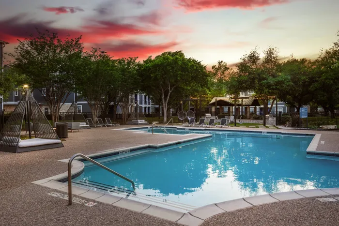 sparkiling pool with seating at sunset