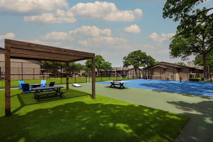 Outdoor fitness area at Oak Park Apartments in Euless, TX, with exercise equipment and a spacious layout.